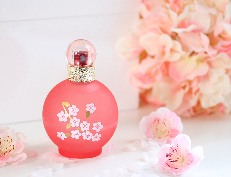 pink perfume bottle surrounded by pink flowers