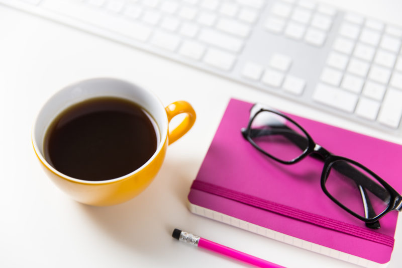 desktop with keyboard and coffee cup